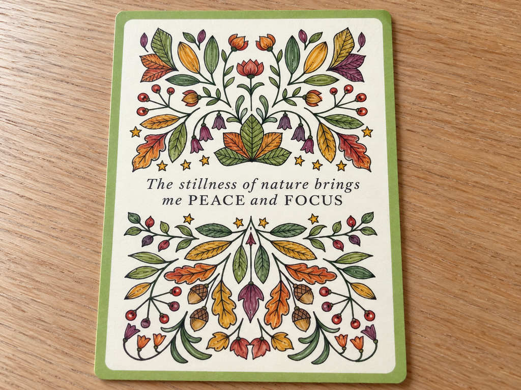 Johanna Basford Notes from Nature affirmation card colored with autumn leaves, acorns, berries and flowers.